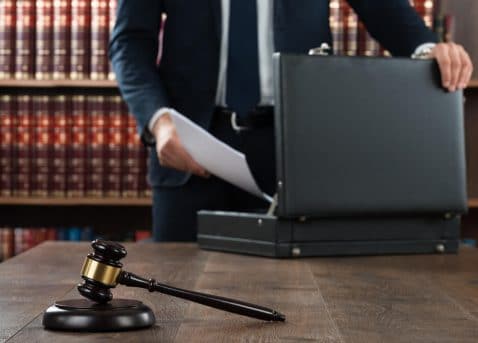 Lawyer Putting Documents In Briefcase - Deakle-Johnson Law Firm, PLLC