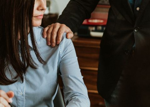 Businessman patting a colleague on her shoulder